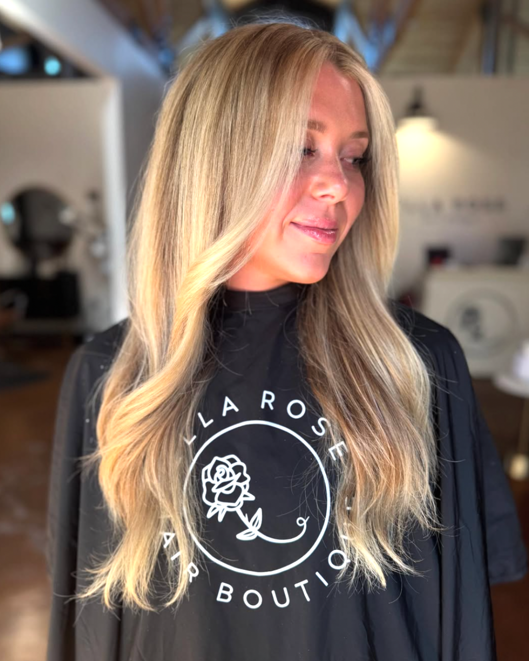 Woman with long creamy blonde hair featuring soft dimensional blonde tones and smooth layers.