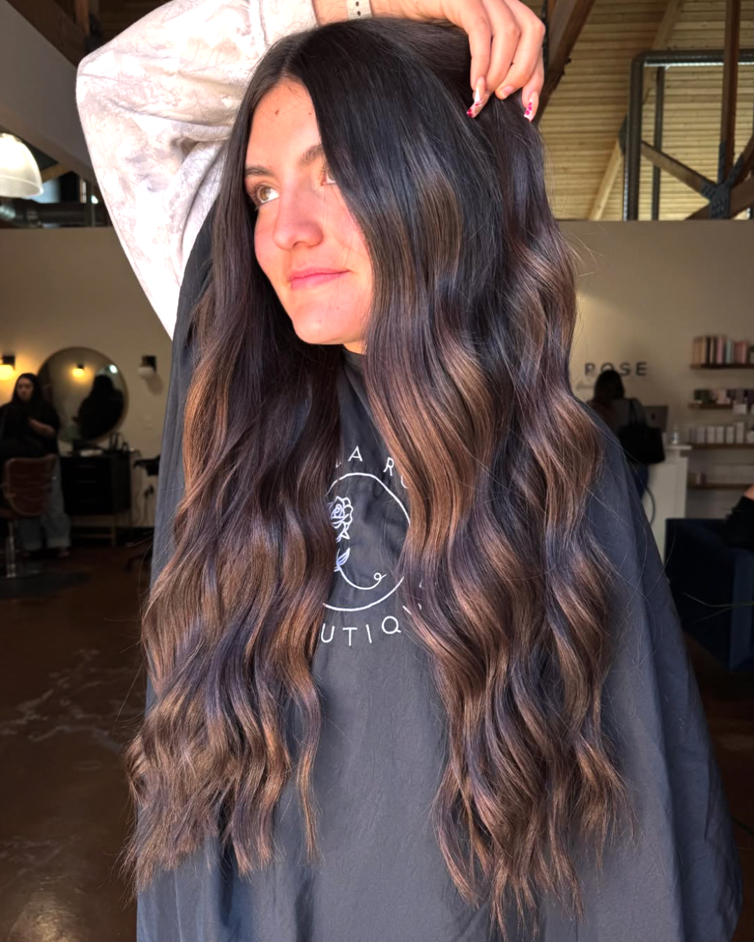 Woman with very long wavy hair in a rich, mocha brunette color