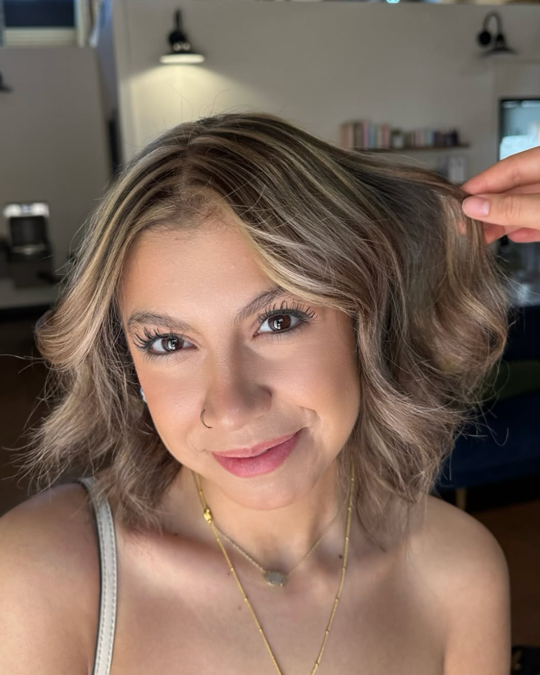 Woman with brunette hair and chunky blonde highlights for dimension