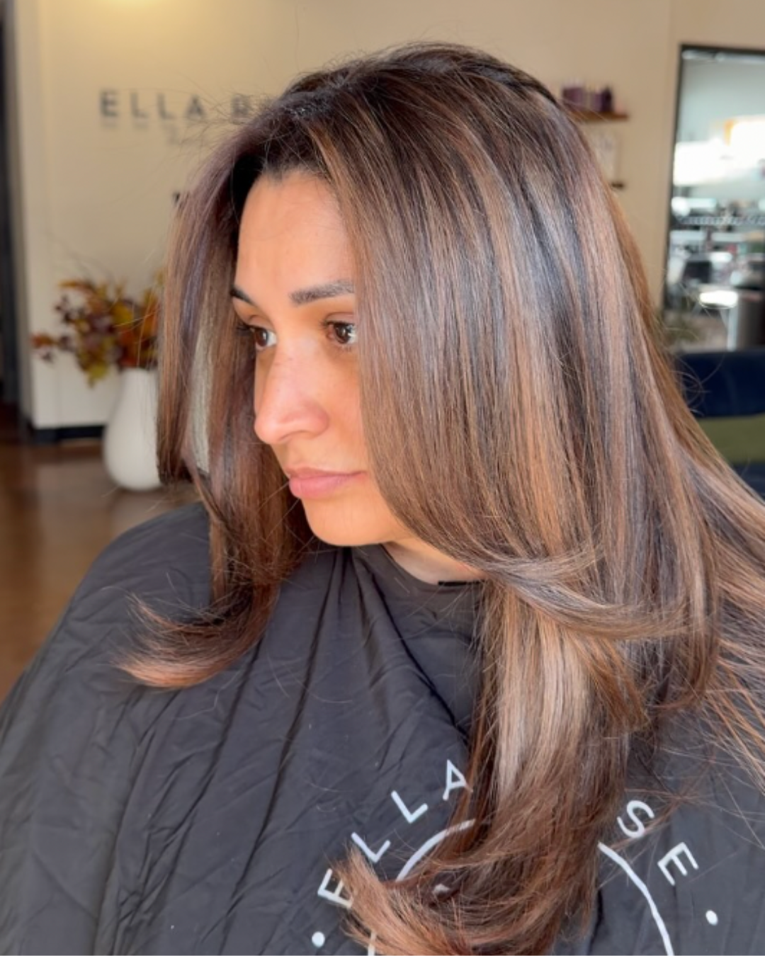 Woman with medium length brunette hair featuring blended darker and lighter tones throughout