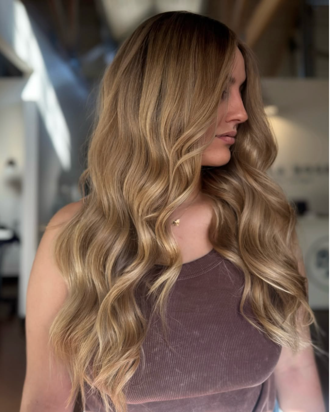 Women with long wavy hair in a dimensional, golden blonde color