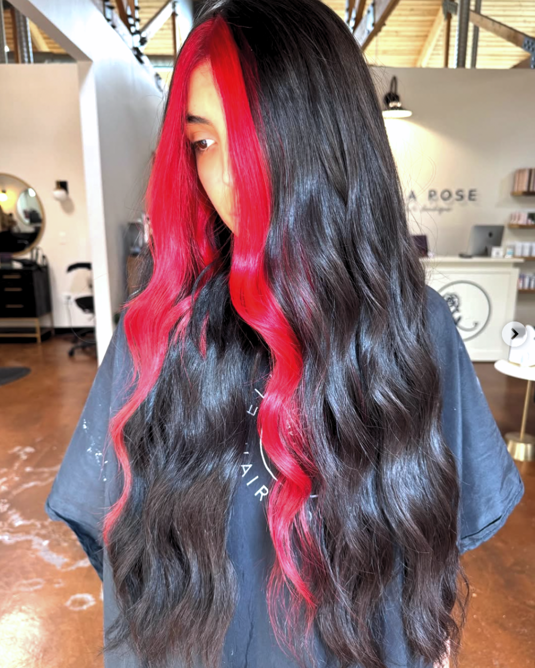 Woman with long black hair and vivid red money pieces