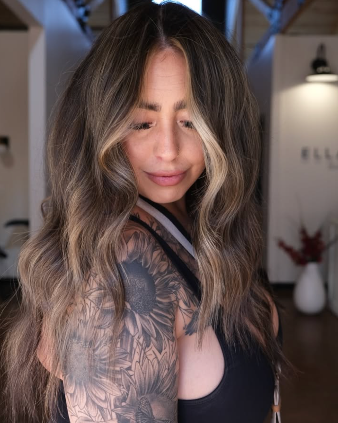 Woman with bronde hair and bright blonde face framing