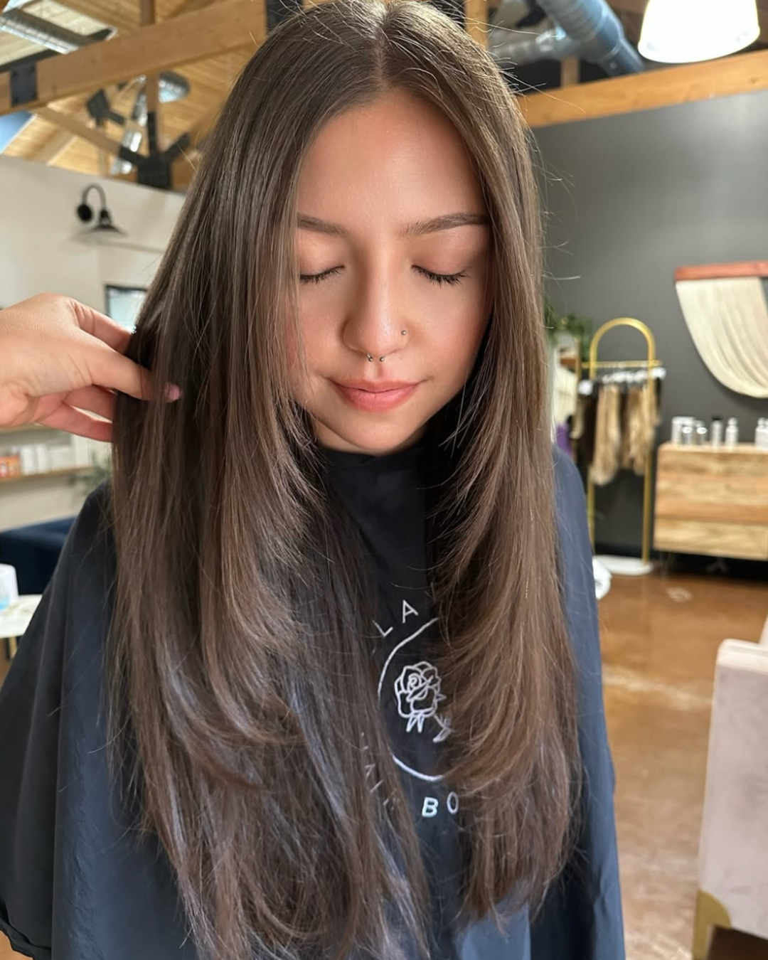 Woman with long layers and sharp face framing pieces